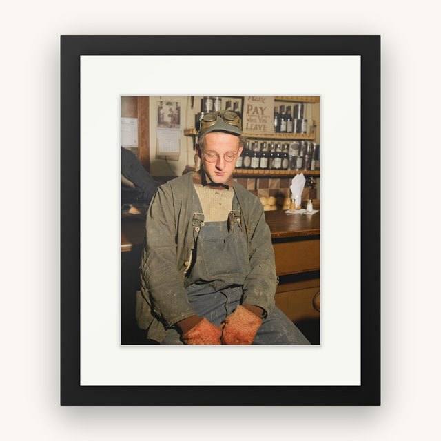 An 8 by 10 print in a black classic frame with a white mat